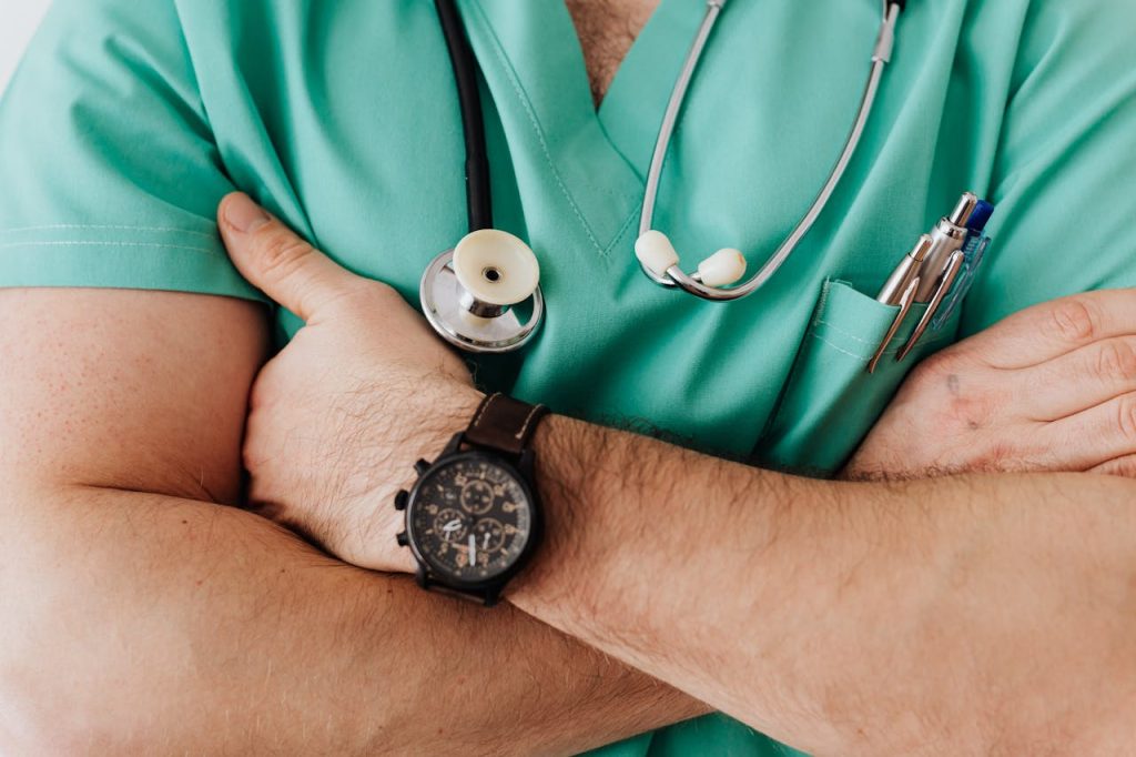 Crop unrecognizable male doctor with stethoscope